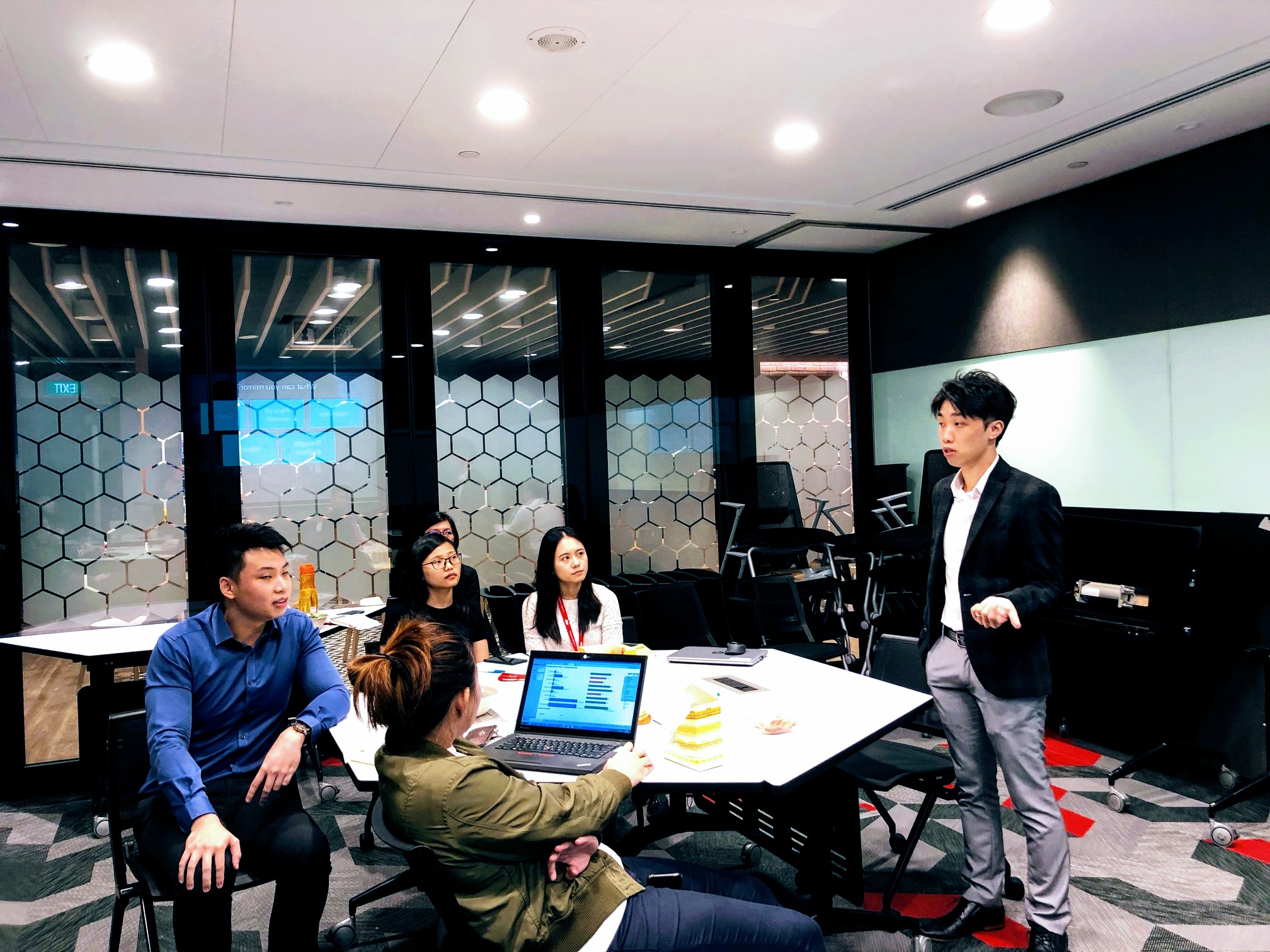 Sam Neo speaking to a workshop group in a professional training setting.